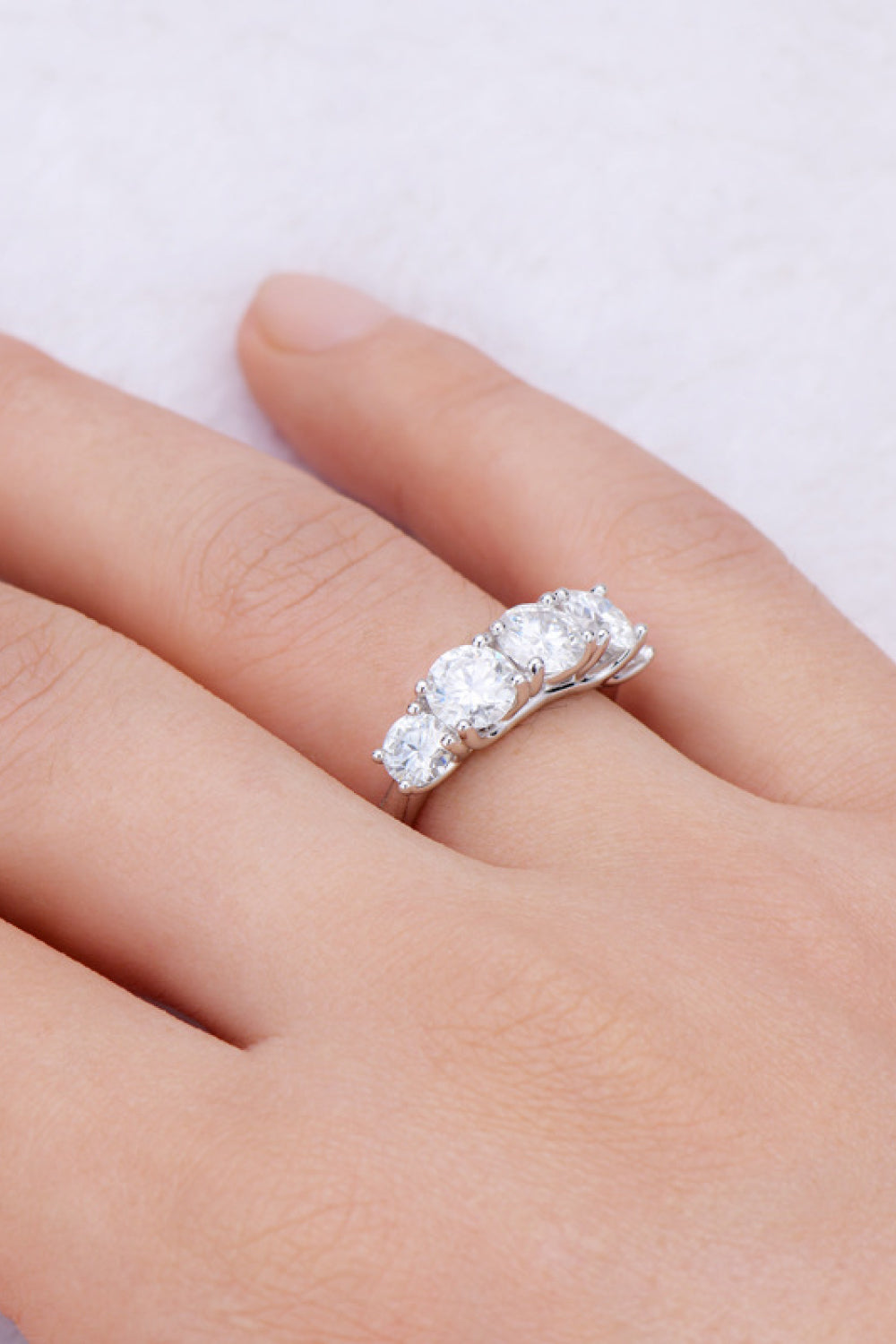 Close-up of the half eternity Moissanite Ring with 1-carat stone on hand